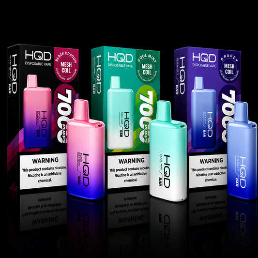 HQD Bar 7000 disposable vape collection featuring Black Dragon, Cool Mint, and Grapey flavors with retail packaging on black background